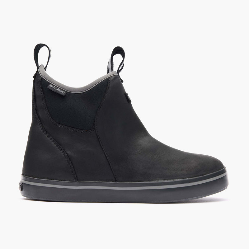 Black slip-on boot with gray sole on a white background