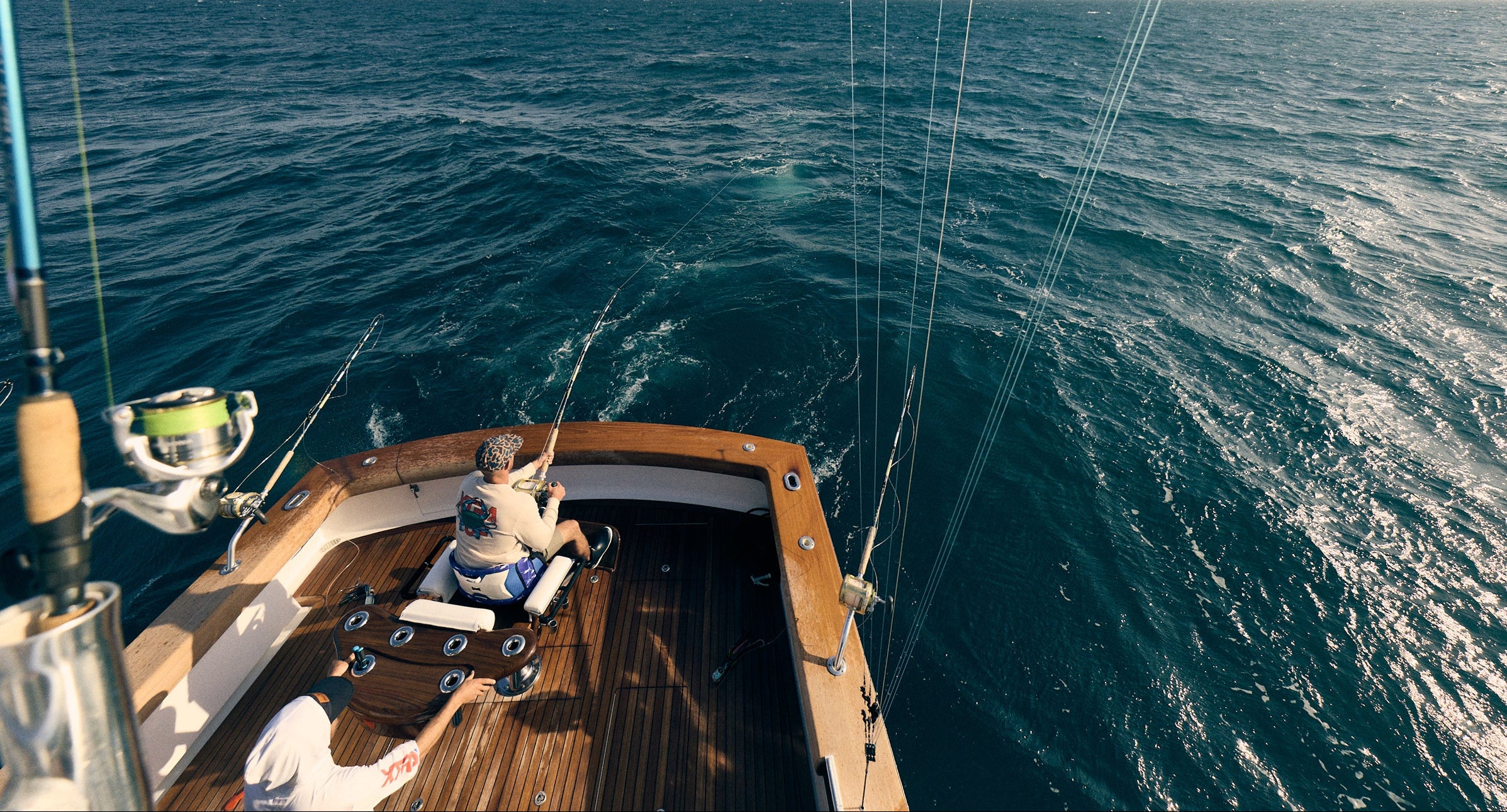 Two people on a sailboat in the middle of the ocean