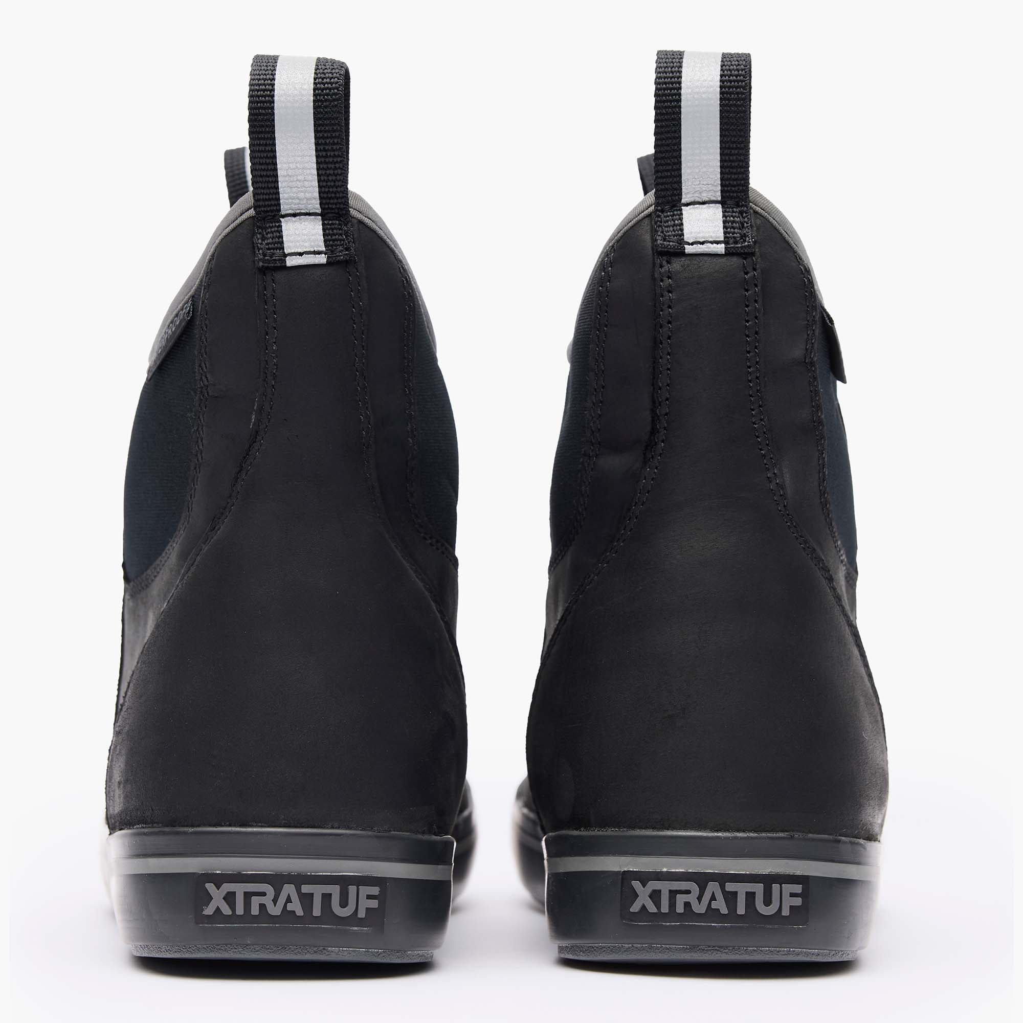 Black Xtratuf boots with visible branding on a white background