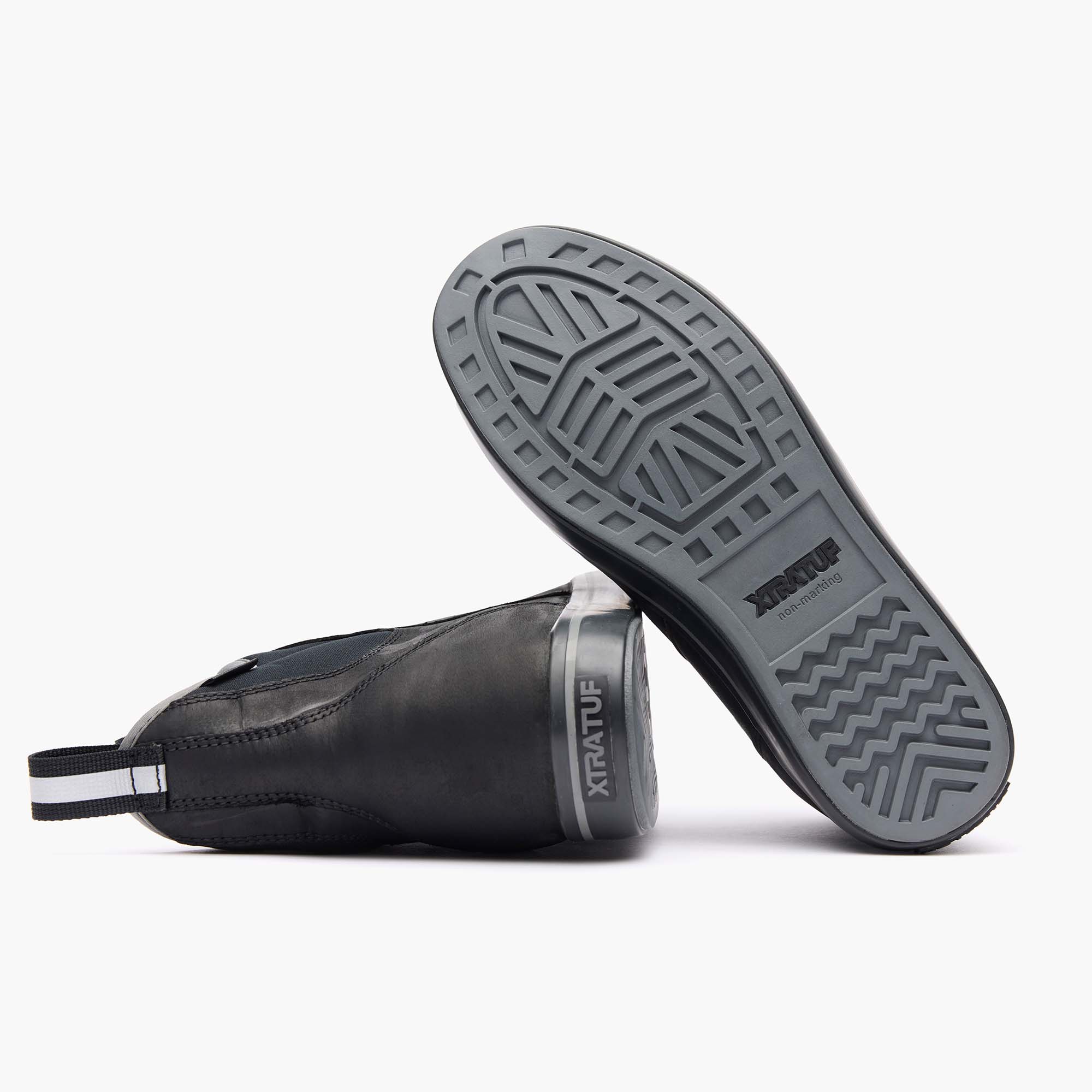 Black rubber boot sole with tread pattern on a white background