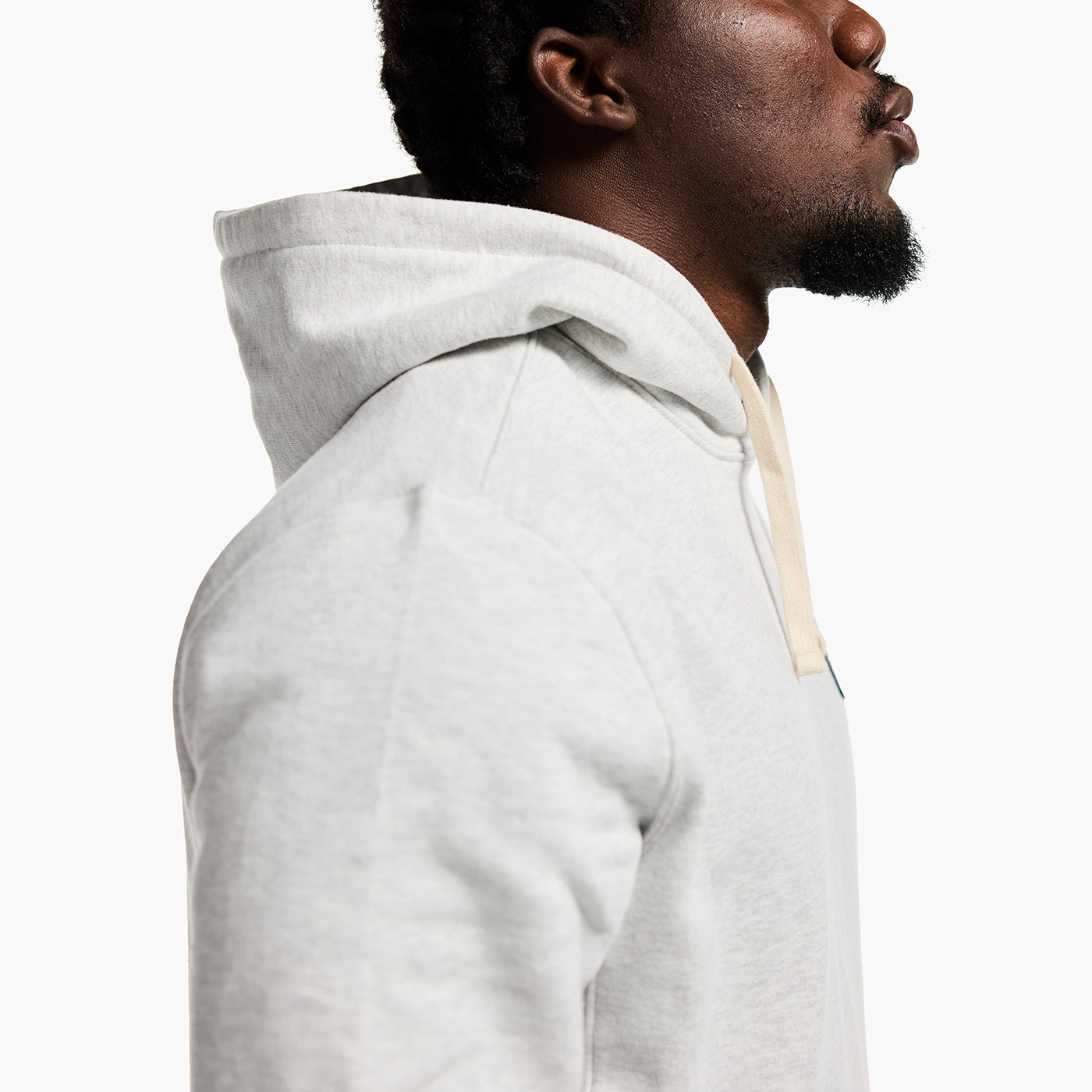Person wearing a gray hoodie on a white background