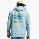 Person wearing a light blue hoodie with fish graphic and 'XTRATUF' branding on the back.