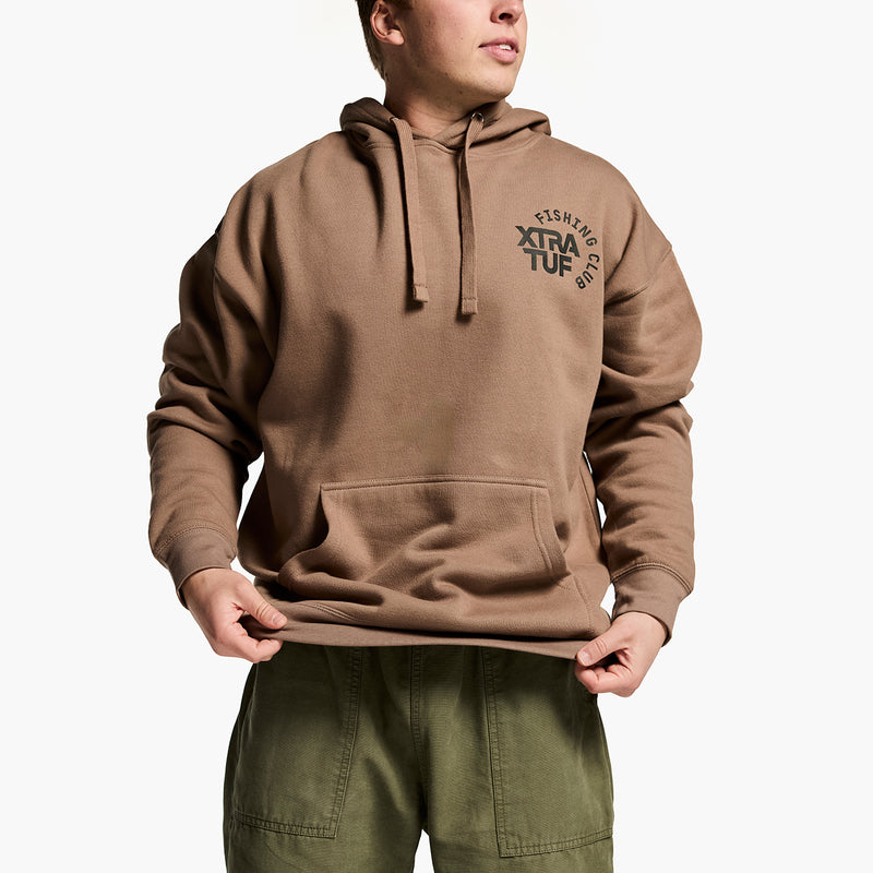 Person wearing a brown hoodie with 'Xtra Tuf' logo on a white background