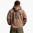 Person wearing a brown hoodie with 'Fish Club Extravaganza' text and design on the back.