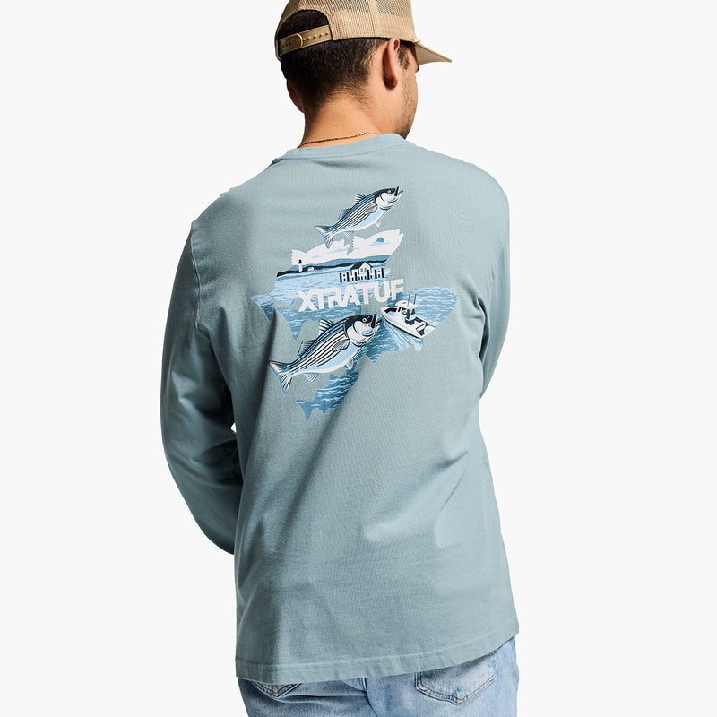 Person wearing a long-sleeve shirt with fish graphics and 'Xtratuf' branding on the back.
