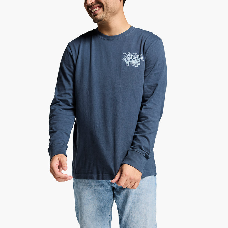 Man wearing a blue long-sleeve shirt with a logo on a white background