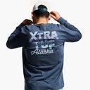 Person wearing a blue long-sleeve shirt with 'Xtra Tuf Alaska' text on the back.