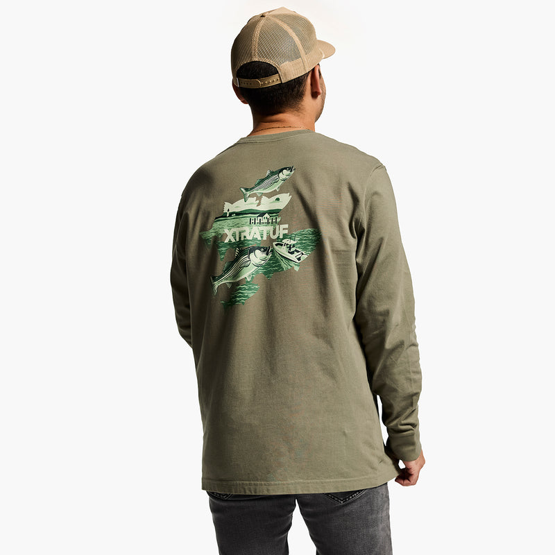 Person wearing a green long-sleeve shirt with a fish design on the back, standing against a white background.