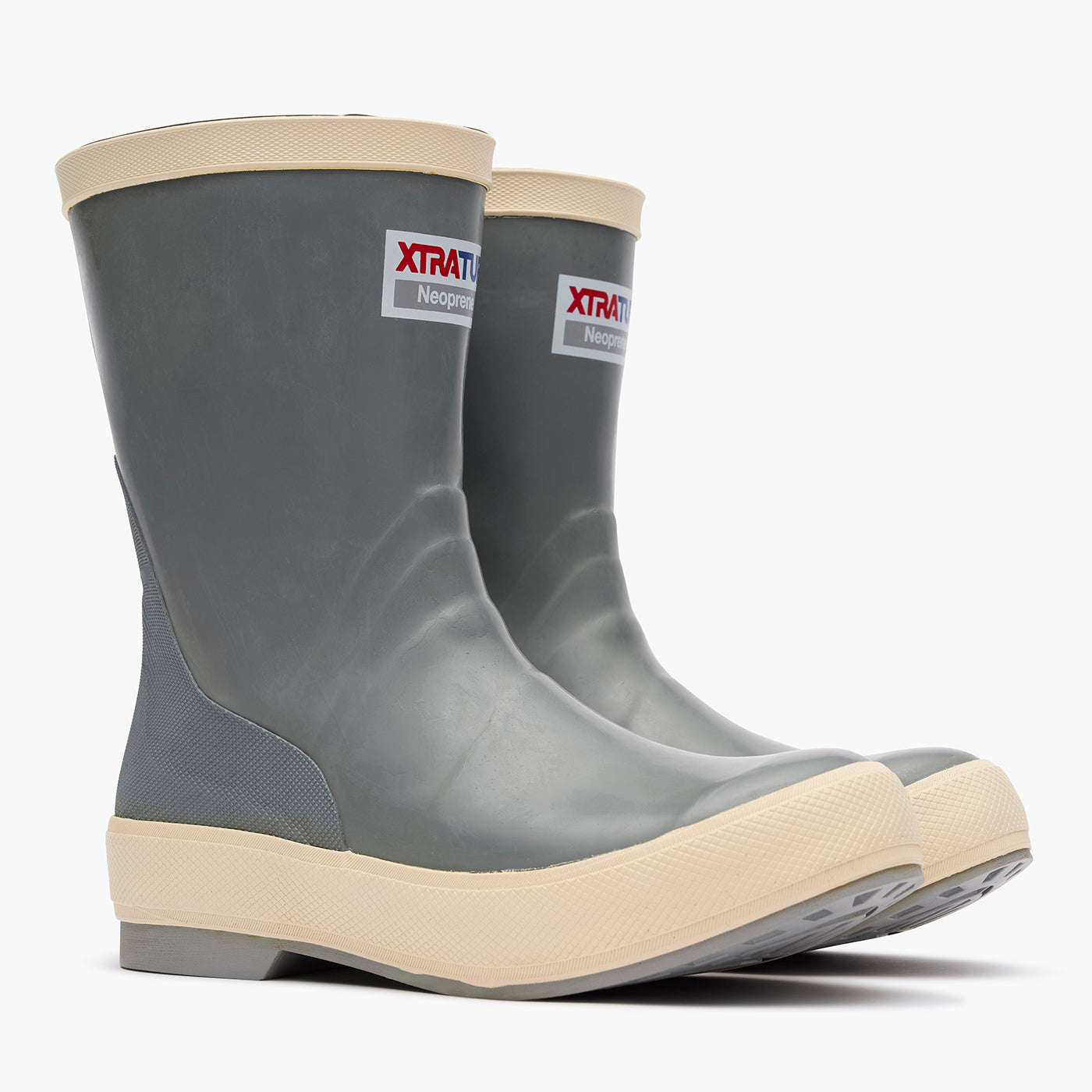 Pair of gray rubber boots with beige soles on a white background